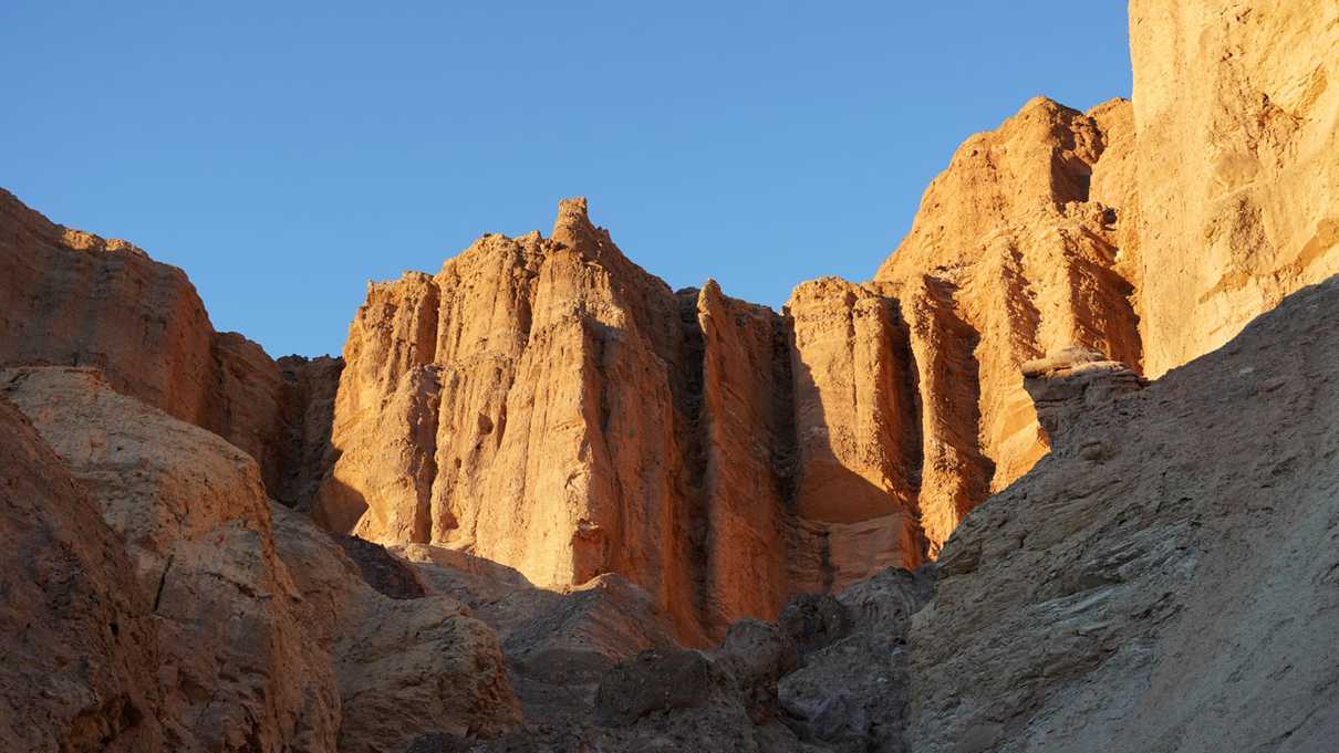 Sunlight shines on red cliff walls of Red Cathedral