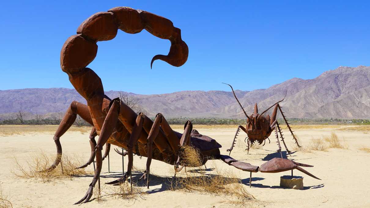 Giant metal scorpion fighting grasshopper